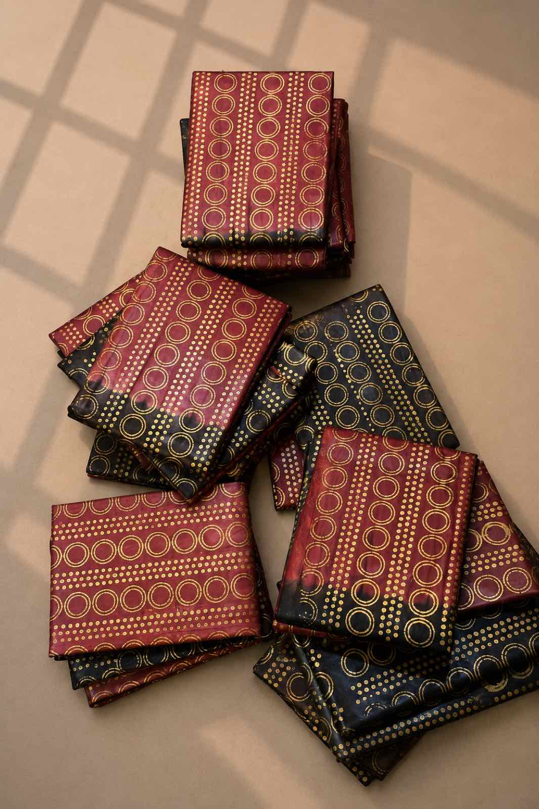 A Rini design, deep red with gold circle motifs