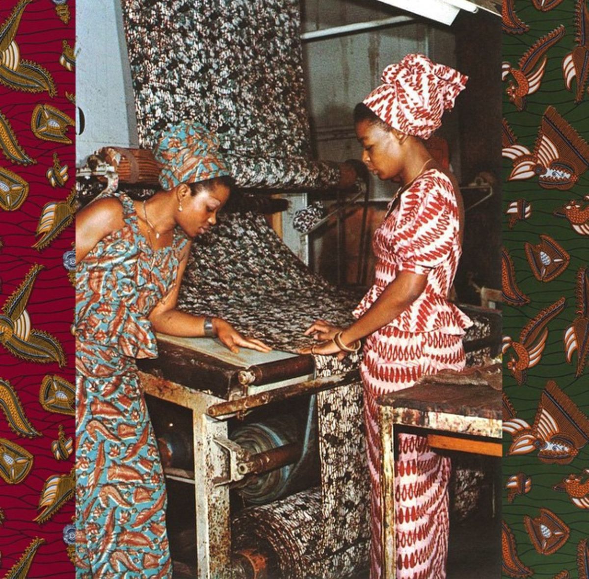 A wax-print pattern being rolled onto cloth